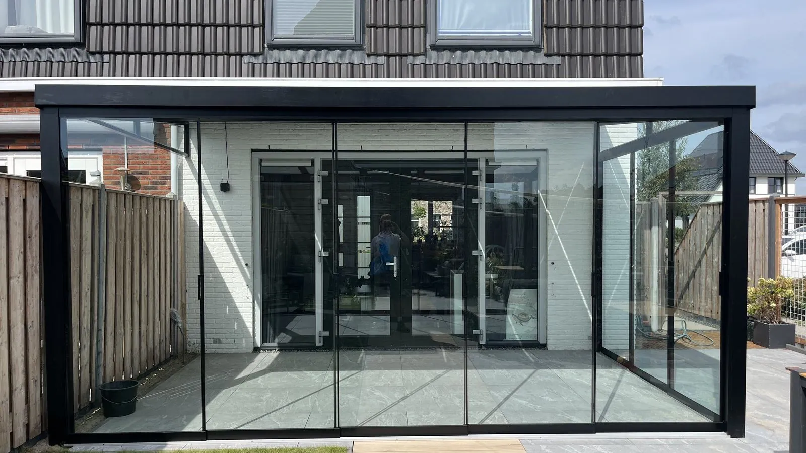 Aanbouw met doorlopende glazen pui aan de achterzijde van een woning